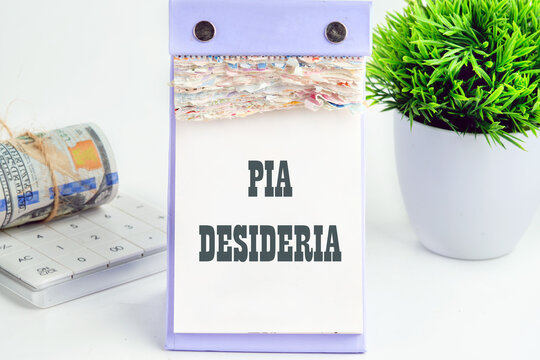 PIA DESIDERIAPIA the phrase in Latin means Good intentions on a piece of a desktop calendar with tear-off pages