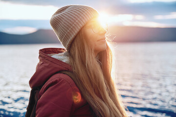 Pretty smiling woman in warm clothes travelling outdoor
