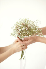 close-up of mom and baby's hands on a white background