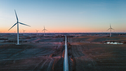 Aerial view of road leading through wind farm in Iowa.