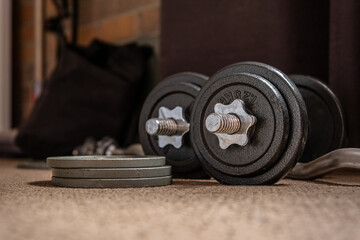 Old used gym weights. Close up of worn dumbbell, fitness equipment in run down gymnasium