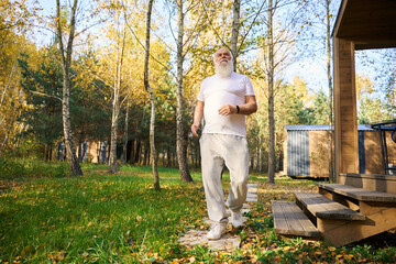 Fototapeta premium Strong old man left the house for a morning jog outdoors