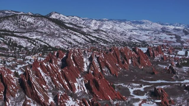 Stunning March winter morning snow Roxborough State Park Littleton Colorado aerial drone sharp jagged dramatic red rock formations Denver foothills front range landscape blue sky circle left motion