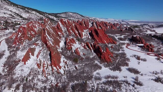 March winter morning snow stunning Roxborough State Park Littleton Colorado aerial drone landscape sharp jagged dramatic red rock formations Denver foothills front range blue sky forward motion