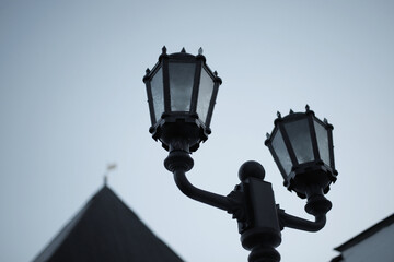 vintage street lamp made of forged metal on the background of the evening sky
