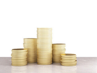 Stacks of golden coins increasing in height on a smooth surface, against a clean white background, concept of growth in finance