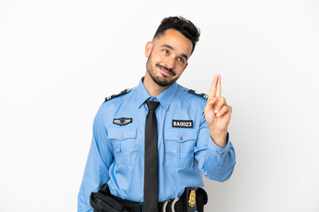 Police caucasian man isolated on white background with fingers crossing and wishing the best