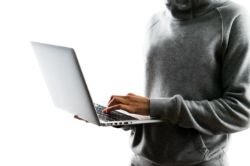 A person in a gray hoodie using a laptop, photographed against a white background, illustrating the concept of remote work or technology use