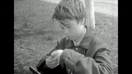 Teenage boy passion for photography. Young man holding photo filter. Creative hobby of younger generation. Archival vintage black white film. Skill increase. Old retro archive video. 1980s Crimea