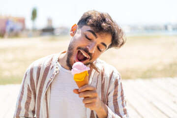 Handsome Arab man at outdoors with a cornet ice cream