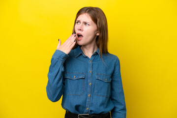 Young English woman isolated on yellow background yawning and covering wide open mouth with hand