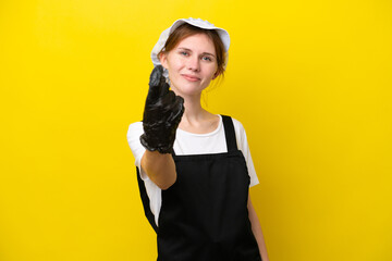 Young English fisherwoman isolated on yellow background doing coming gesture