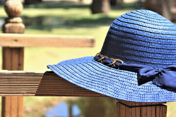 Blue Sunhat on Old Fence Post