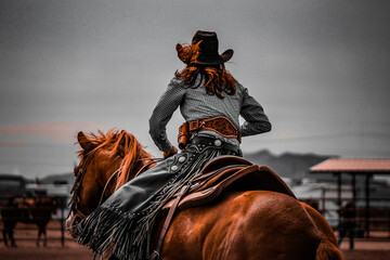 Cowgirl On Horse Riding Into Storm