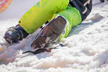 skier puts on ski boots on a snowy slope. active holiday with family