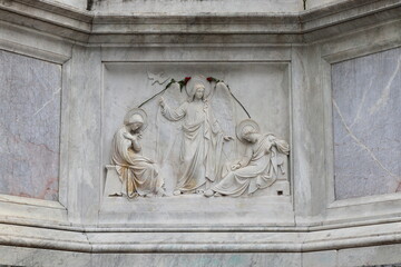 Religious Relief at the Base of the Column of the Immaculate Conception at Piazza Mignanelli Square in Rome, Italy