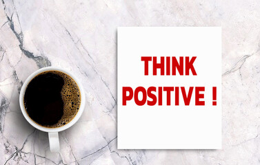 Business quotes, THINK POSITIVE on notebooks or paper in office desk, office workplace, inspiration, motivation