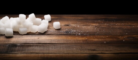 Several sugar cubes are spread out haphazardly on a rustic wooden table, creating a sweet and textured display - Powered by Adobe