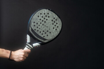 Man ready for paddle tennis serve in studio shot  - 771322717
