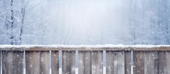 Wooden fence in a snowy winter scene with snowflakes falling gently, creating a serene background for various concepts or projects