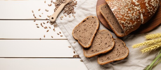 Slices of rye bread with sunflower seeds, freshly baked goods, and healthy food on a wooden table, perfect for appetizers or snacks, with a rustic background and top view - obrazy, fototapety, plakaty