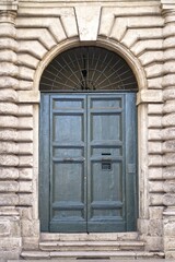 doors of Rome. Classic old wooden door in a public place on a city street or in an urban environment