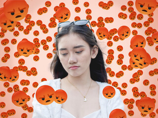 A woman appears distressed by numerous negative social media reacts and emojis. Flooded with angry...