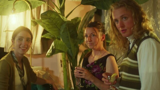 Group of friends make faces at cocktail party.