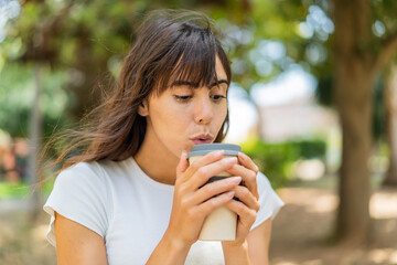 Young woman at outdoors holding a take away coffee