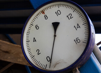 Old round manometer with scale and arrows close-up