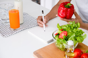 Young woman embraces joyful moments in kitchen.