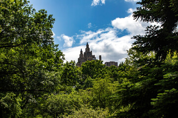 A New York City skyscraper as seen from Central Park which is a public urban park located in the...