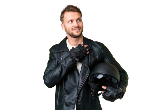Young caucasian man with a motorcycle helmet over isolated chroma key background looking up while smiling