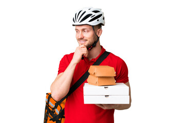Young delivery man taking a takeaway food over isolated chroma key background looking to the side and smiling