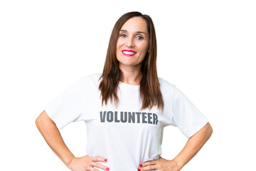 Middle age volunteer woman over isolated chroma key background posing with arms at hip and smiling