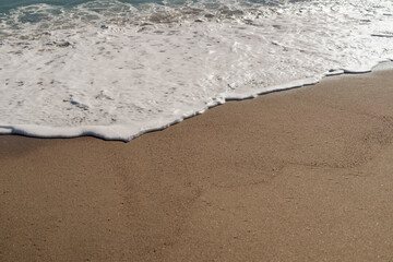 Warm day on a Cannes beach with azure waves of mediterranean sea