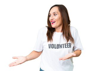Middle age volunteer woman over isolated chroma key background with surprise facial expression