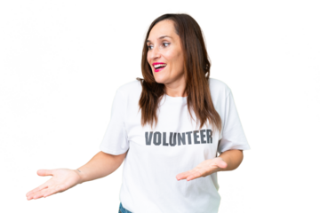 Middle age volunteer woman over isolated chroma key background with surprise facial expression