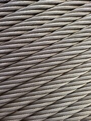 Grey Steelcable, macro shot, vertical, for Background and Industry. Wire rope is composed of two...