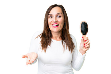 Middle age woman with hair comb over isolated chroma key background with shocked facial expression