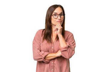 Middle-aged caucasian woman over isolated background having doubts and thinking