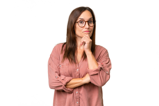 Middle-aged caucasian woman over isolated background having doubts and thinking