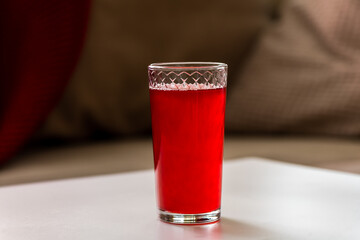red lingonberry cranberry juice is on the table