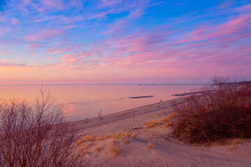 A beautiful spring sunset landscape of a Baltic Sea beach in Riga, Latvia. Colorful evening scenery of Northern Europe.
