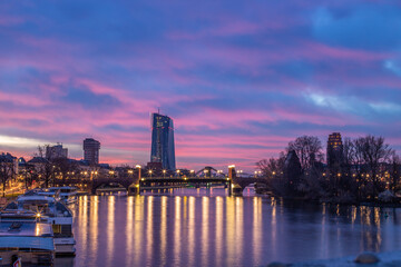 Sunrise on a river bank in the middle of a big city. Spring with a view of the skyline of the...