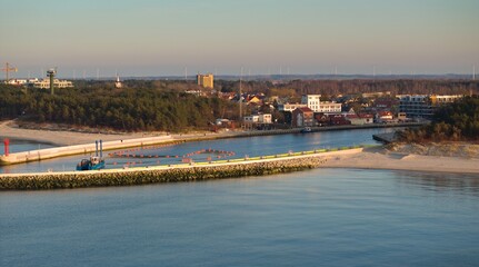 Naklejka premium Mrzeżyno port in West Pomeranian Voivodeship, Poland, during golden hour in February.