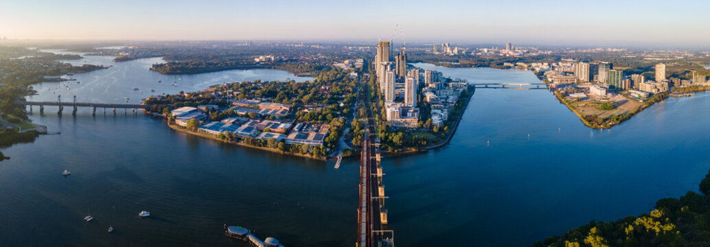 Panoramic aerial drone view of Rhodes and Wentworth Point, showing Homebush Bay and Parramatta River in Sydney, NSW Australia on a sunny morning in March 2024 