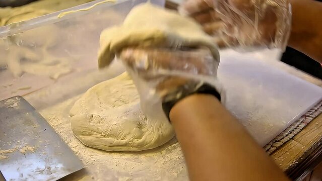 The cakwe dough is given flour while pressing it, Street Food