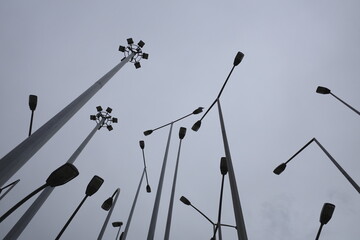 Lampposts in the city against cloudy sky - 771378557