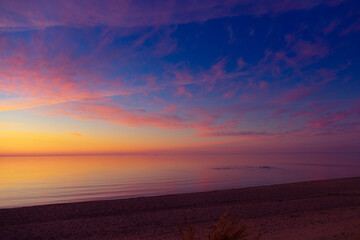 A beautiful spring sunset over the Baltic Sea with colorful skies and calm water. Natural evening...